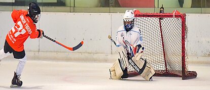 An ice hockey striker trying to score