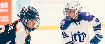 Two young ice hockey players facing each other