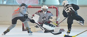 A striker trying to score in ice hockey