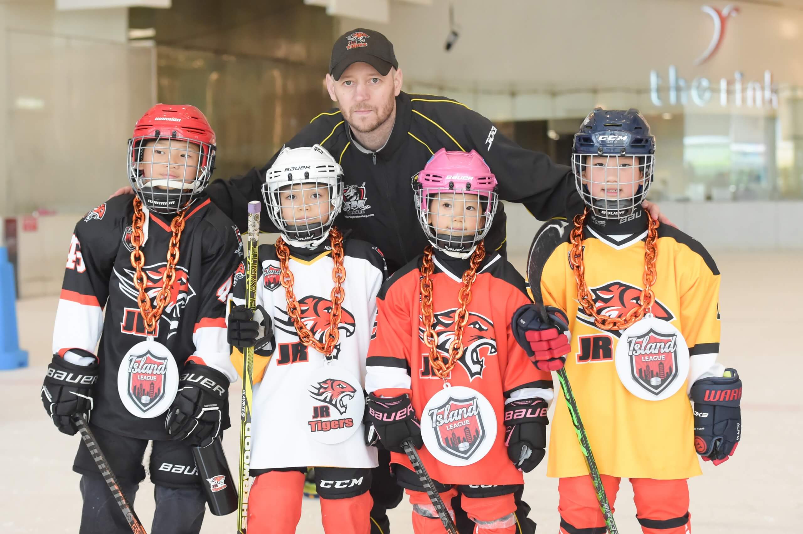 A coach and the young ice hockey players